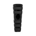 A black orthopedic knee immobilizer brace with multiple adjustable straps and an open kneecap area, shown upright against a white background; clinical, practical appearance.